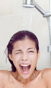 Woman dealing with inconsistent water temperatures from shower