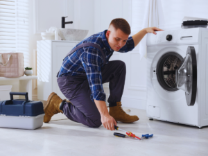 Plumber fixing laundry drain that keeps backing up
