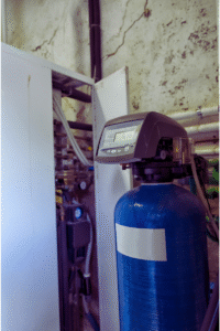 Water softener installed in basement where it's near electrical outlet and drain